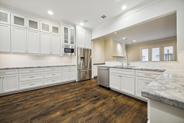 kitchen featuring sink, white cabinetry, appliances with stainless steel finishes, dark hardwood / wood-style floors, and decorative backsplash