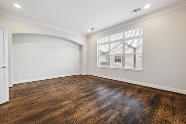 empty room with crown molding and dark wood-type flooring