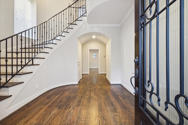 foyer with crown molding and dark hardwood / wood-style floors