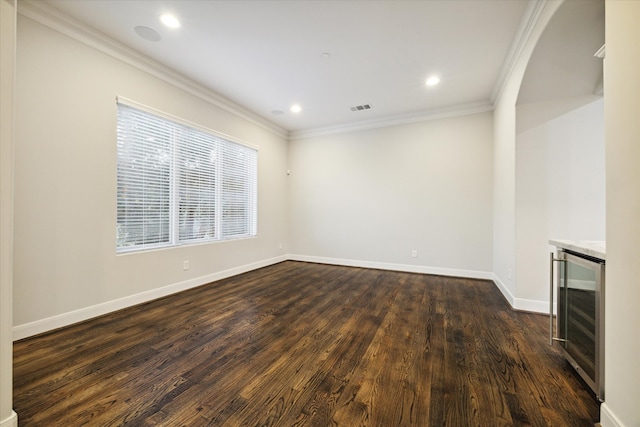 interior space featuring wine cooler, dark wood-type flooring, and crown molding