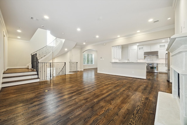 unfurnished living room featuring crown molding, dark hardwood / wood-style floors, and a high end fireplace