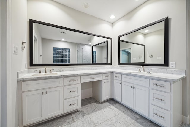 bathroom with vanity and a shower