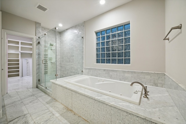 bathroom featuring independent shower and bath