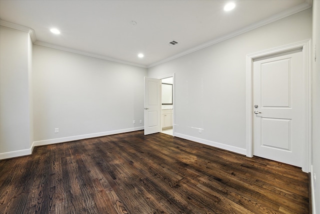 spare room with dark wood-type flooring and crown molding