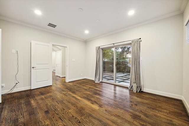 spare room featuring ornamental molding and dark wood-type flooring