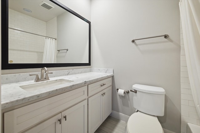 bathroom featuring vanity, toilet, and a shower with shower curtain