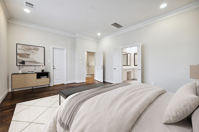 bedroom with dark hardwood / wood-style floors, ornamental molding, and ensuite bath