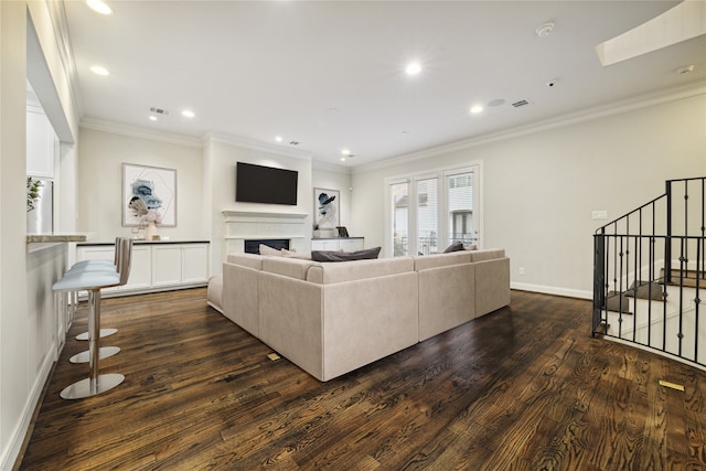 living room with crown molding and dark wood-type flooring