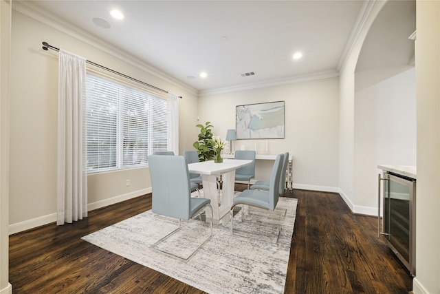 dining area featuring wine cooler, dark hardwood / wood-style floors, and crown molding