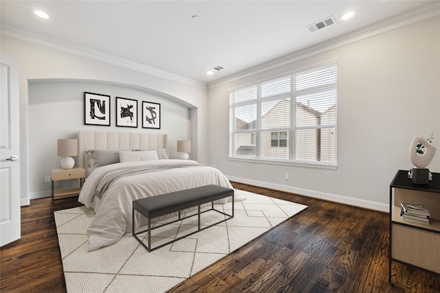 bedroom with crown molding and dark wood-type flooring