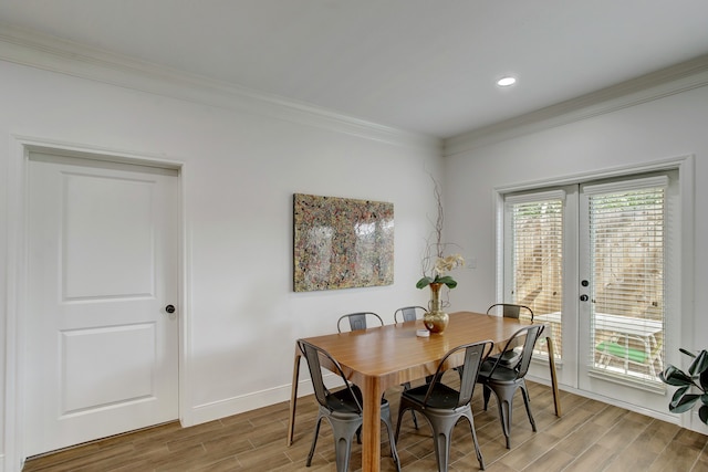 dining room with hardwood / wood-style floors and ornamental molding