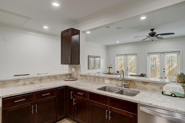 kitchen with light stone counters, stainless steel dishwasher, crown molding, and sink