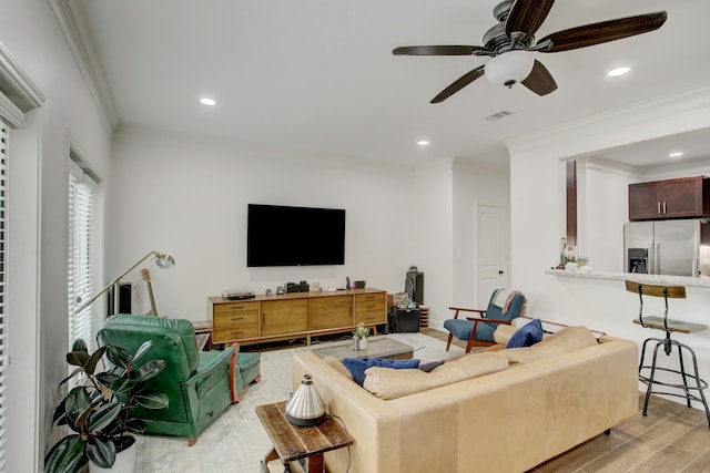 living room featuring ceiling fan and ornamental molding