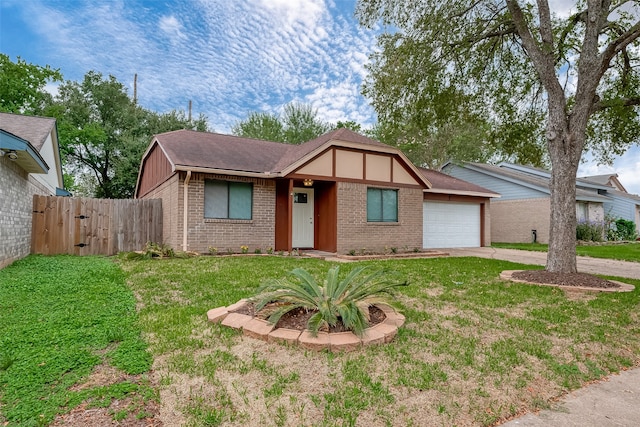 view of front of home with a front yard and a garage