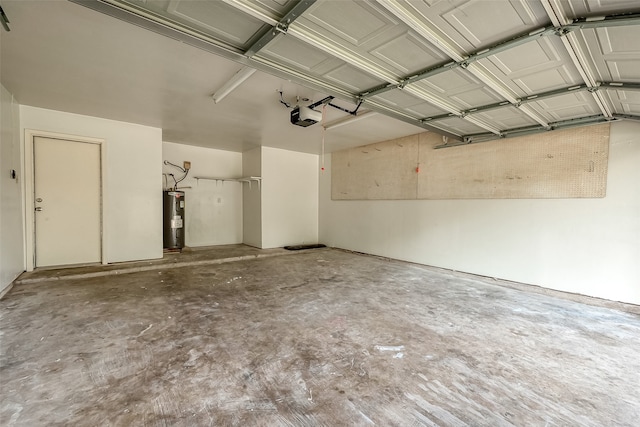 garage with a garage door opener and electric water heater