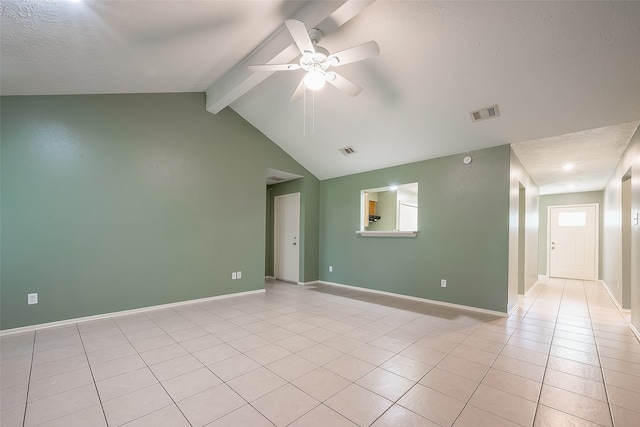 empty room featuring vaulted ceiling with beams, ceiling fan, and light tile patterned floors