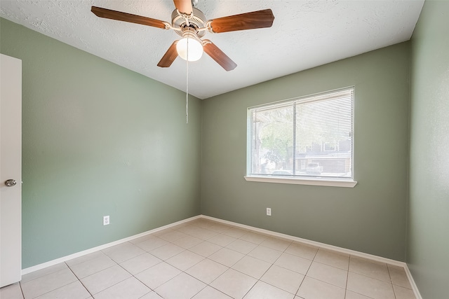 tiled spare room featuring ceiling fan and a textured ceiling