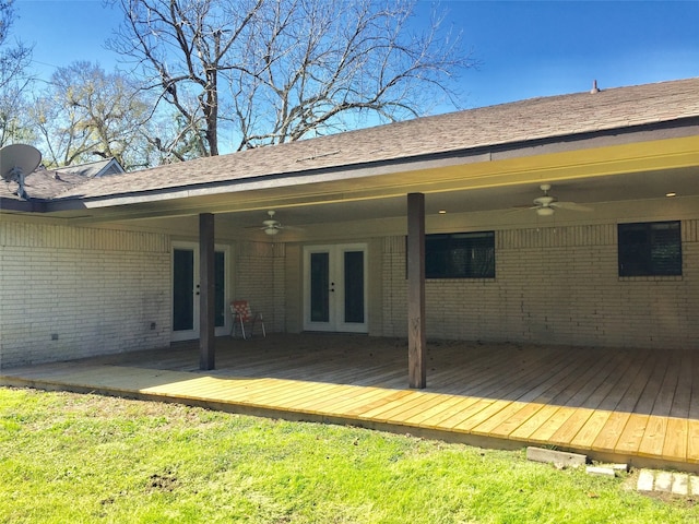 rear view of house featuring french doors, a deck, a lawn, and ceiling fan