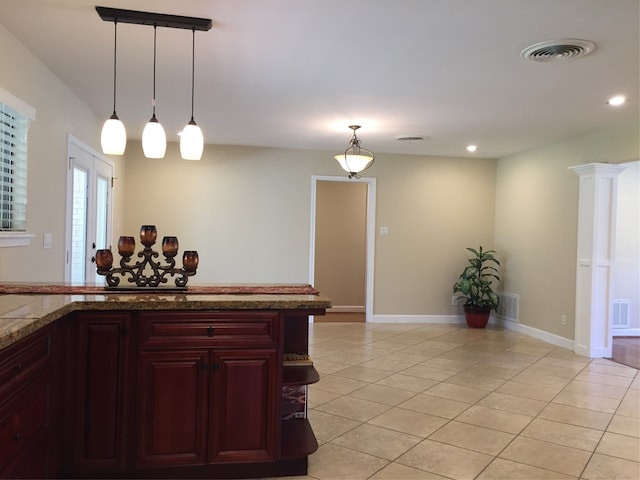 kitchen with light tile patterned flooring and decorative light fixtures