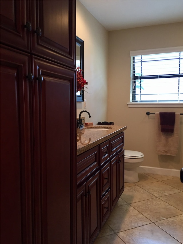 bathroom with tile patterned flooring, vanity, and toilet