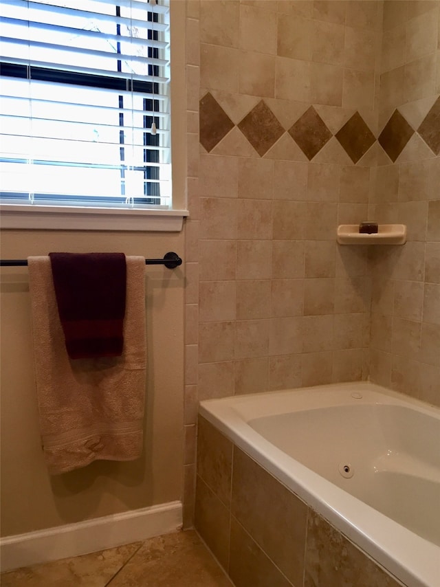 bathroom with tiled tub and tile patterned floors