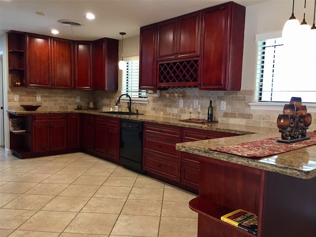 kitchen featuring a healthy amount of sunlight, hanging light fixtures, black dishwasher, and sink