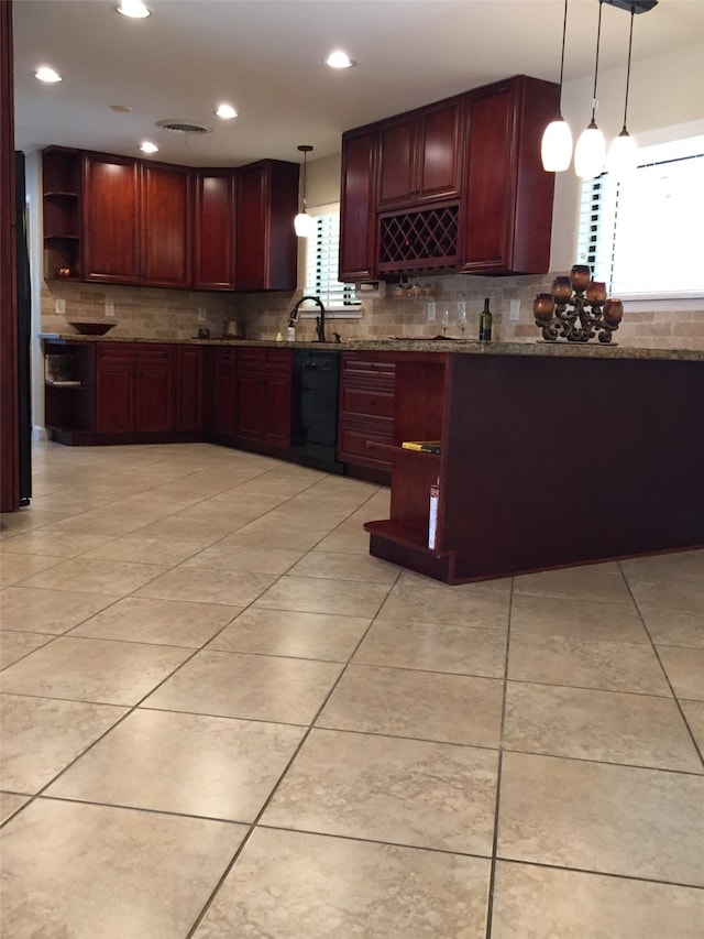 kitchen with black dishwasher, decorative light fixtures, sink, and decorative backsplash