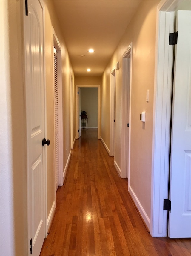 hall with wood-type flooring