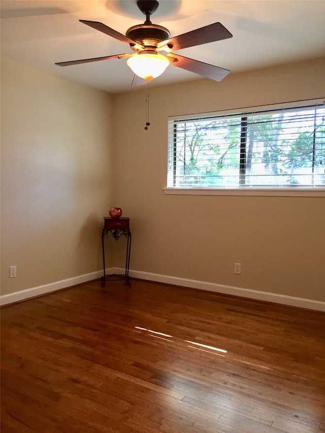 unfurnished room featuring ceiling fan and dark hardwood / wood-style flooring