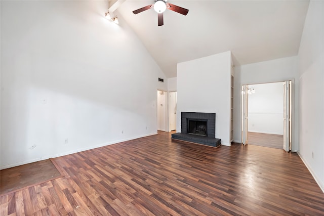 unfurnished living room with high vaulted ceiling, dark hardwood / wood-style flooring, ceiling fan, and a brick fireplace