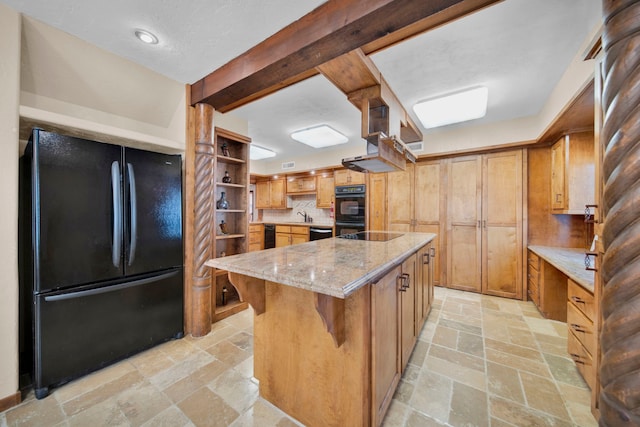 kitchen with a breakfast bar, a center island, sink, black appliances, and light stone countertops