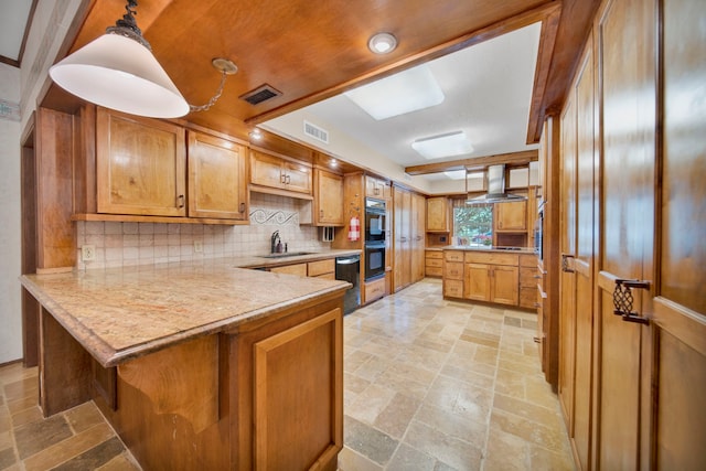 kitchen with backsplash, kitchen peninsula, decorative light fixtures, sink, and wall chimney range hood