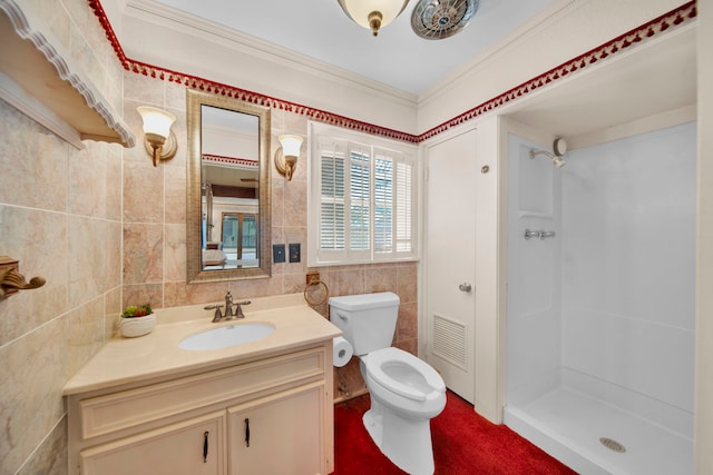 bathroom with tile walls, vanity, toilet, and a shower