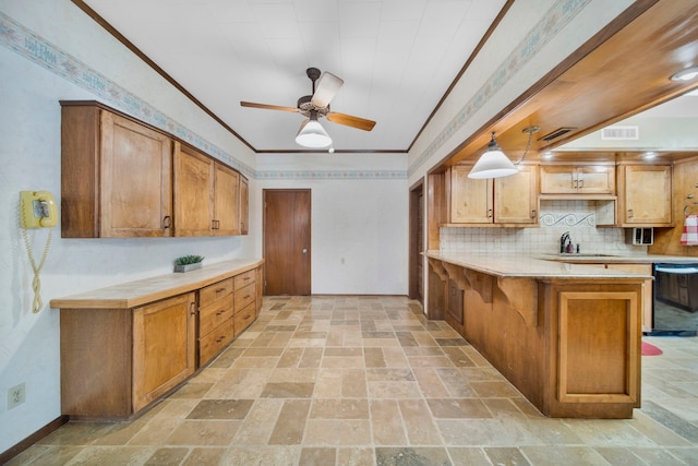 110 Monroe St, Giddings, TX 78942 - kitchen featuring brown cabinetry, black dishwasher, light countertops, and visible vents