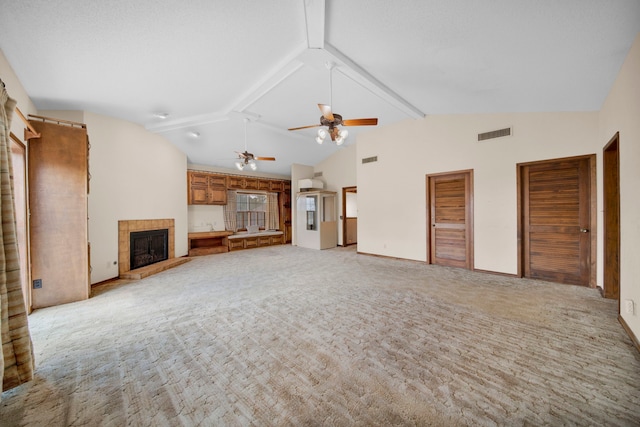 unfurnished living room with a tile fireplace, ceiling fan, and light colored carpet