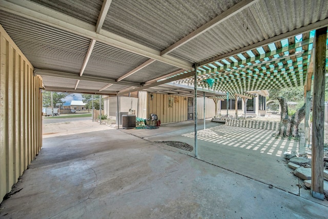 view of patio / terrace featuring a pergola, a storage unit, and central AC