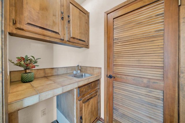 kitchen with tile counters and sink