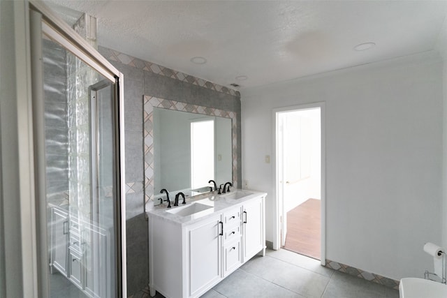 bathroom featuring vanity, a textured ceiling, tile patterned floors, and tile walls