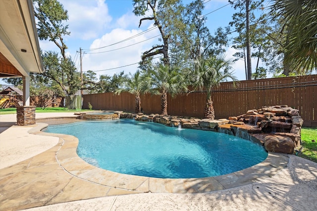 view of pool with pool water feature and a patio