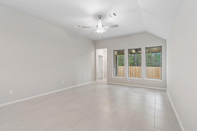 spare room with light tile patterned floors, visible vents, baseboards, ceiling fan, and vaulted ceiling