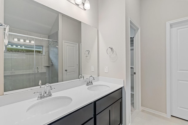 full bathroom with double vanity, a sink, and a shower stall