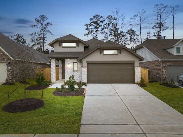 view of front of house featuring a garage, a shingled roof, concrete driveway, stucco siding, and a front yard