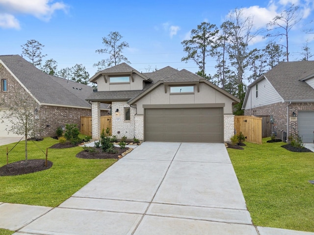 view of front facade featuring a garage, fence, roof with shingles, stucco siding, and a front lawn