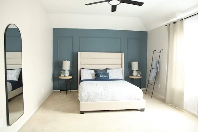 carpeted bedroom with vaulted ceiling and ceiling fan