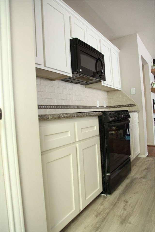 kitchen with white cabinetry, light hardwood / wood-style flooring, and tasteful backsplash