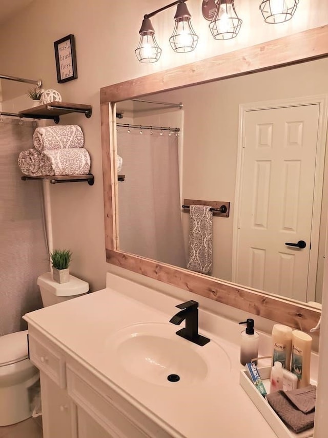 bathroom featuring vanity, toilet, and a shower with shower curtain