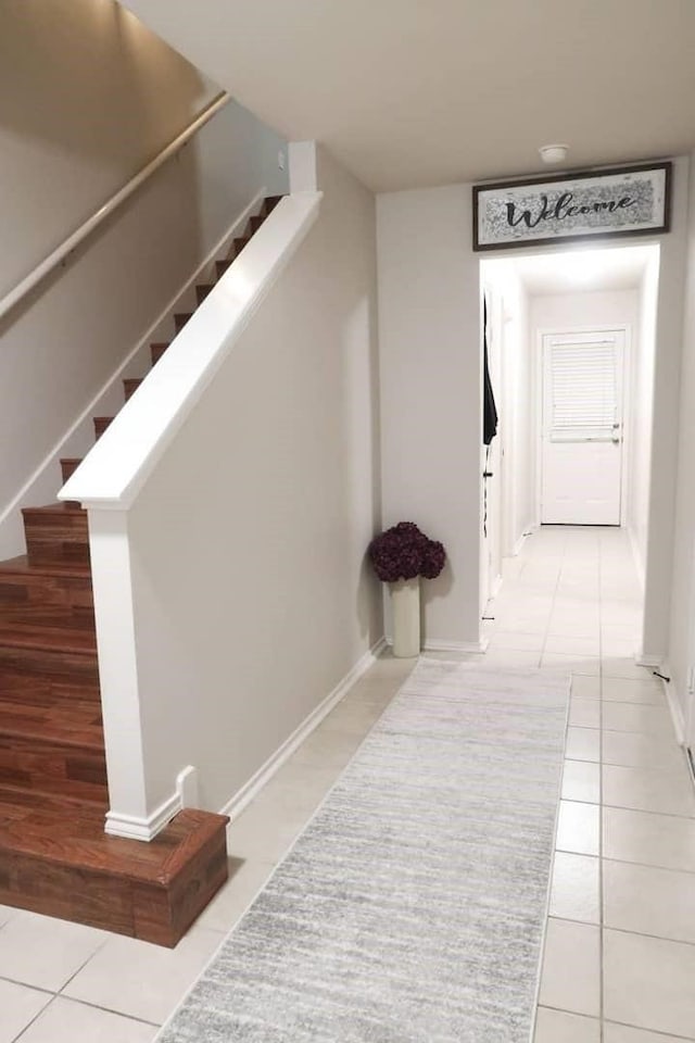 corridor featuring light tile patterned floors