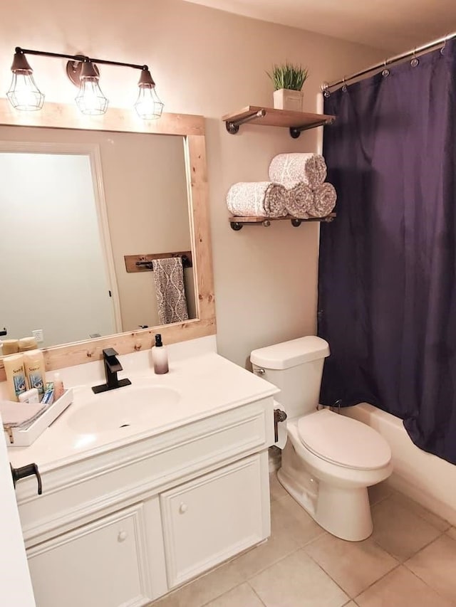 full bathroom featuring shower / tub combo, vanity, toilet, and tile patterned floors