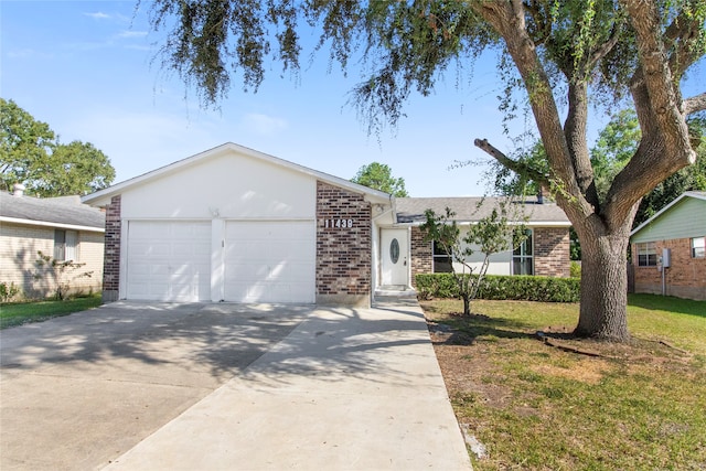 single story home with a garage and a front yard