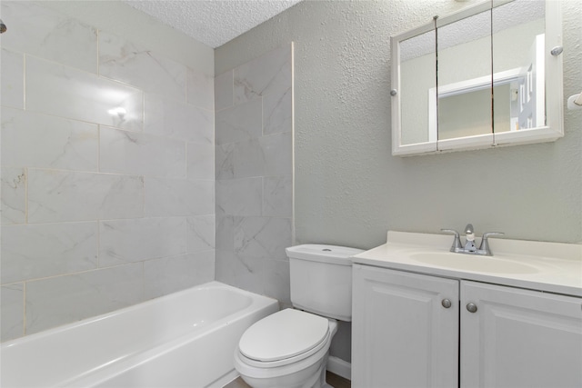 full bathroom with a textured ceiling, tiled shower / bath combo, vanity, and toilet